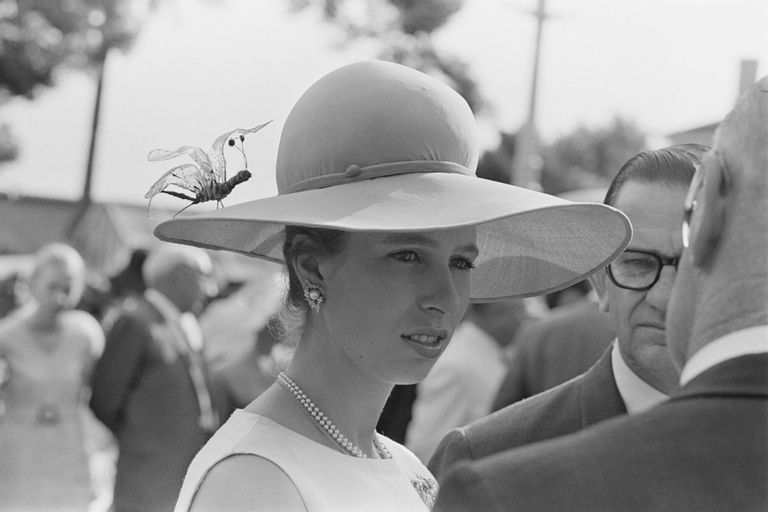 Princess Anne wearing a hat with decorative insect on it