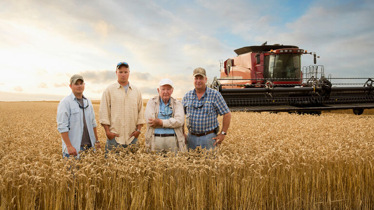 Three generations of Caucasian farmers in wheat field