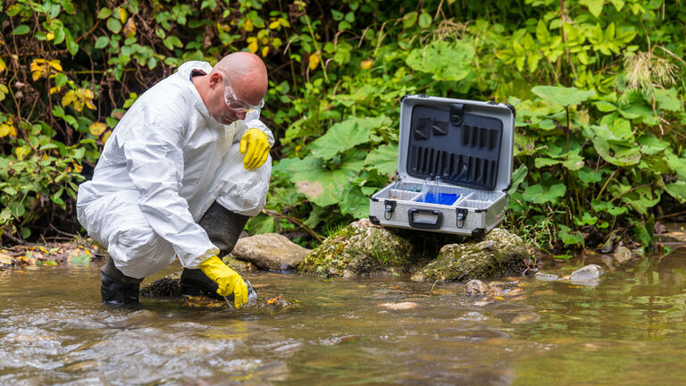 Scientist examing toxic water