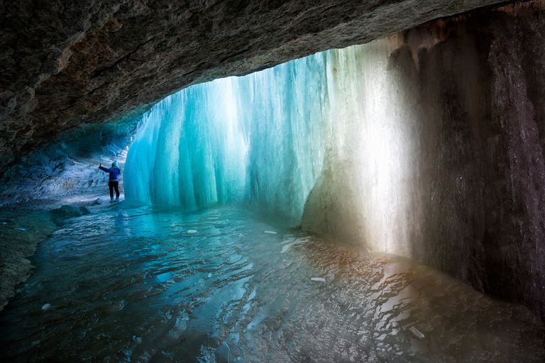 https://www.gettyimages.co.uk/detail/photo/grotto-with-turquoise-ice-behind-frozen-waterfall-royalty-free-image/489565632 frozen waterfall