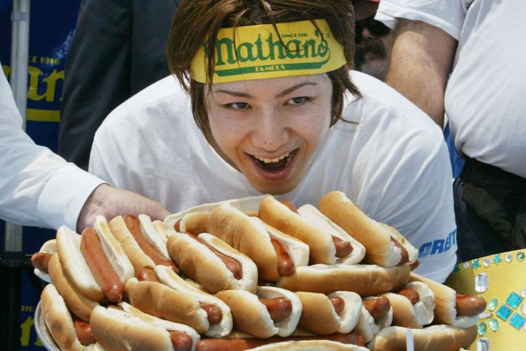https://www.gettyimages.co.uk/detail/news-photo/takeru-kobayashi-of-japan-smiles-over-the-pile-of-hot-dogs-news-photo/2136956?phrase=hot%20dog