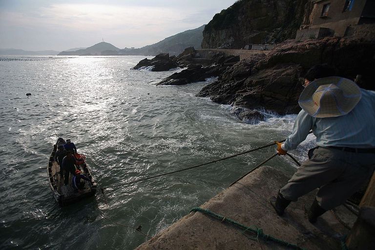 https://www.gettyimages.com/detail/news-photo/fisherman-drags-a-boat-carrying-his-partners-at-coastal-news-photo/71352641?adppopup=true
