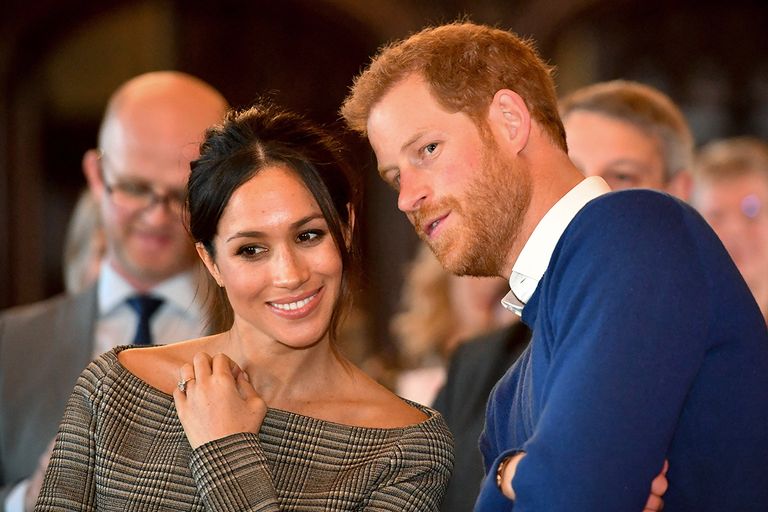 https://www.gettyimages.co.uk/detail/news-photo/prince-harry-whispers-to-meghan-markle-as-they-watch-a-news-photo/906665892
